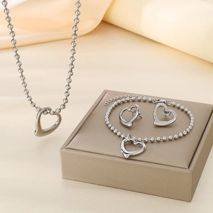 Silver stainless steel jewelry set with hollow heart pendants on beaded chains
