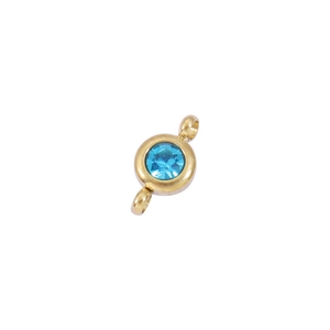 Detailed close-up of a 6.5mm gold stainless steel birthstone pendant with sky blue crystal