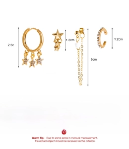 Detailed view of 18K gold alloy ear clip set with zircon inlay and hanging stars