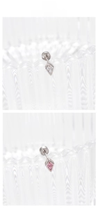 Macro detail of geometric kite-shaped zircon stud earrings in silver and pink colors
