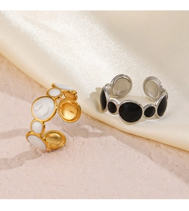 Macro shot of gold and silver drip oil geometric rings on elegant silk and stone background