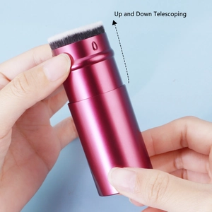 Detail showing the up and down telescoping mechanism of the rose red makeup brush