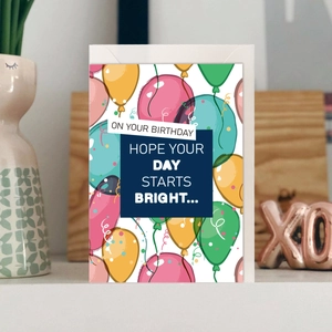 Minimalist birthday card set with colorful balloons and greeting text in a lifestyle setting