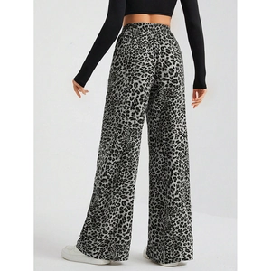 Detail shot of leopard print wide-leg trousers showing high waist and fluid fabric texture