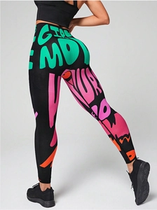 Detail of high waisted yoga leggings featuring colorful graffiti prints and seamless texture