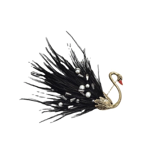 Elegant black swan brooch featuring gold metal, natural feathers, and white pearl accents