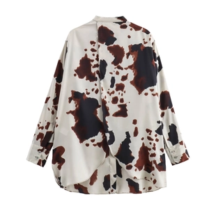 Women's autumn fashion cow print shirt featuring stylish back slit design on white background