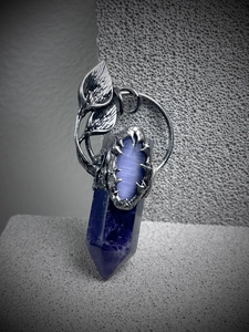 Detailed silver vine pendant with purple hexagonal crystal and cat eye stone on stone