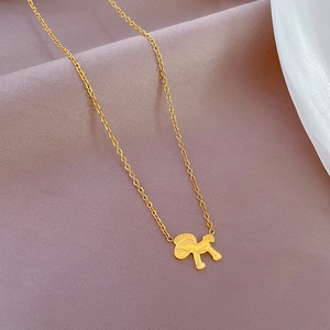 Close-up of a minimalist gold horse pendant on a titanium steel necklace chain