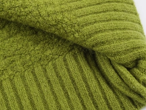 Macro shot of soft moss green ribbed knit fabric with a plush wool texture detail