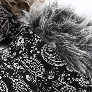 Close-up of paisley pattern fabric and fluffy grey wig detail on a baseball cap