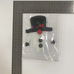 Christmas gnome plush cutlery holder shown with a metal ruler for size reference