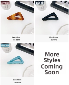 Three minimalist 8.5cm matte triangle shark clips in amber, black, and light blue colors