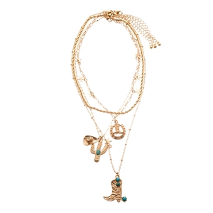 Layered gold necklace with cowboy hat, cactus and horseshoe pendants on white background