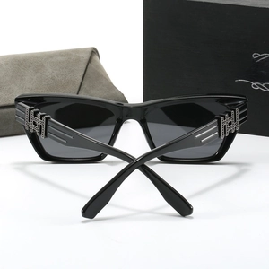 Detail of black polarized cat-eye sunglasses with silver hollow geometric temple decor