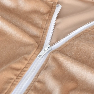 Detailed macro view of high-quality zipper and caramel velvet fabric seam on the hoodie