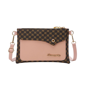 Brown circular print crossbody bag with pink leather trim and golden logo
