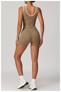 Detail of high-waisted yoga set featuring contrast piping and athletic racerback design