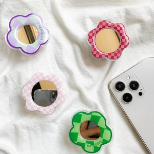 Close-up of four floral checkered phone grips with built-in mirrors in vibrant colors