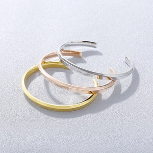 Minimalist C-shaped open bangles in silver, gold, and rose gold with custom engraving