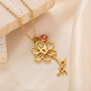 Detail of 18k gold plated stainless steel floral pendant with birthstone gemstone
