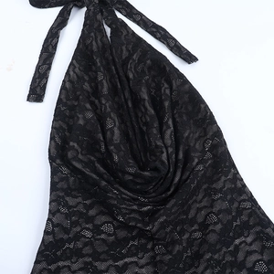 Detail of the black lace halter neck jumpsuit with intricate crochet patterns and ties