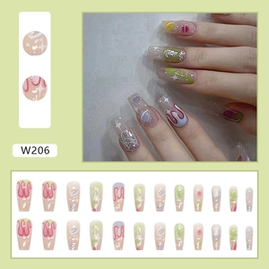 Detail of long square press-on nails with green gradient, pink lines and silver glitters