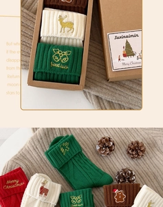 Detail of Christmas cotton socks with reindeer embroidery in a festive gift box
