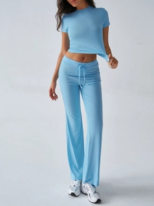 Detail of blue two-piece lounge set featuring short sleeve top and flare pants with drawstring