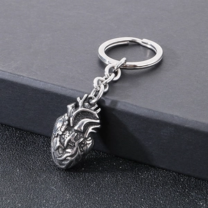 Macro detail of gothic anatomical heart keychain in vintage silver finish with textured veins