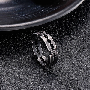 Close-up of vintage dark gray stainless steel ring featuring a unique jagged hollow design