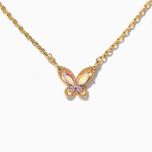Macro shot of gold-plated butterfly necklace with iridescent wings and pink gemstones