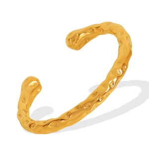 Minimalist open gold cuff bracelet with a hammered texture and irregular polished surface