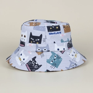 Detail of canvas bucket hat featuring vibrant cartoon cat prints and high-quality texture