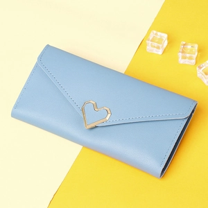 Close-up of light blue long wallet with a golden heart metal buckle on yellow background