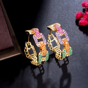 Close-up of gold chain earrings featuring vibrant rainbow gradient cubic zirconia stones