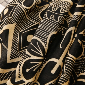 Detailed view of black and gold ethnic geometric pattern on soft cotton linen fabric scarf