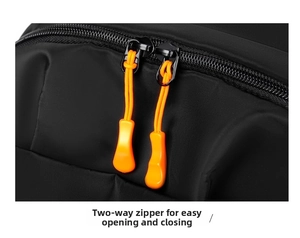 Close-up of ergonomic two-way zippers with orange pull cords on waterproof backpack