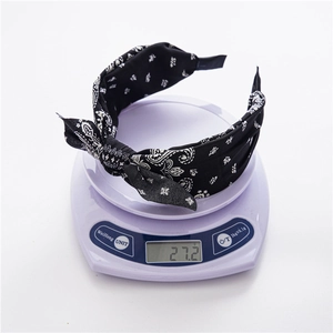 Close-up of paisley print fabric headband on a digital scale showing 27.2g weight