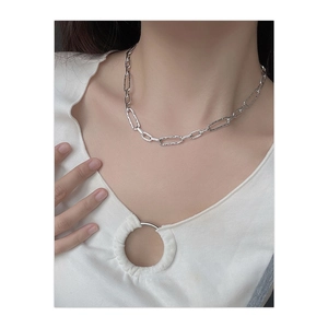 Detail of silver paperclip chain necklace with hammered texture on a model's neck