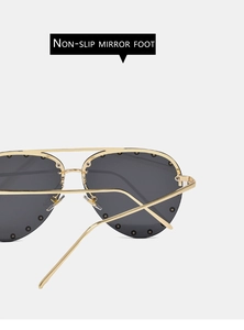 Detailed close-up of golden metal frame sunglasses with non-slip temple design features