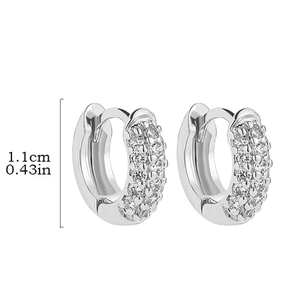 Detailed close-up showing 1.1cm silver hoop earrings with triple row pave-set cubic zirconia