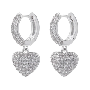 Detailed macro view of silver hoop earrings with micro-pave heart shaped pendants