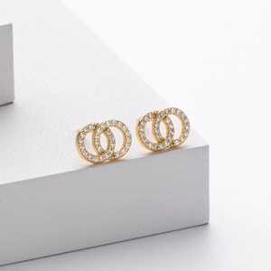 Macro detail of intertwined gold interlocking rings with sparkling pavé zircons