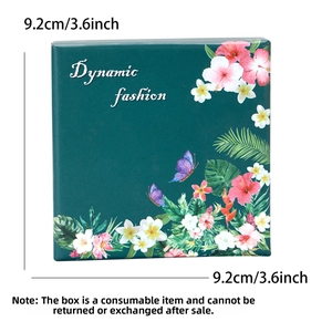 Close-up of deep green gift box with 9.2cm size label and tropical floral pattern