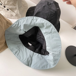 Lightweight nylon bucket hats in multiple colors with 100% nylon fabric texture