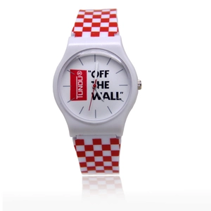 Close-up of white silicone watch featuring red and white checkerboard strap and dial detail