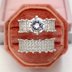 Macro shot of double-layer silver engagement rings with sparkling round-cut zircon crystals