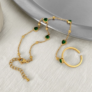 Elegant gold stainless steel hand chain bracelet with multiple emerald green heart stones