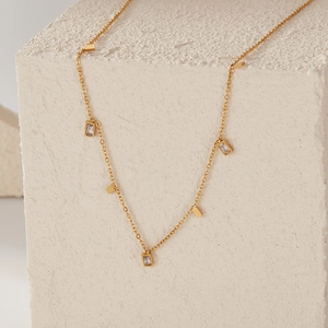 Detailed macro shot of gold square metal pieces and rectangular cubic zirconia pendants